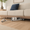 AquaGlide cordless floor washer lying flat to clean under a sofa