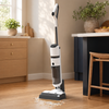 Cordless wet dry vacuum cleaning crumbs and a liquid spill on a kitchen floor