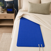 Blue water-circulating bed cooling pad positioned beneath a fitted sheet