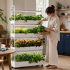 Home gardener harvesting fresh basil from a four-tier hydroponic garden