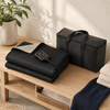 Folded portable sauna blanket with controller and black carrying bag