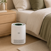 Quiet white air purifier beside a neutral bedroom