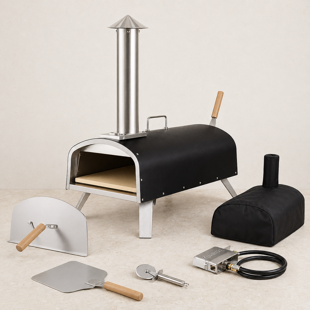 Portable outdoor pizza oven with door, cover, pizza tools, and gas burner attachment