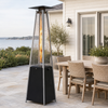 Black pyramid propane patio heater beside a coastal outdoor dining set