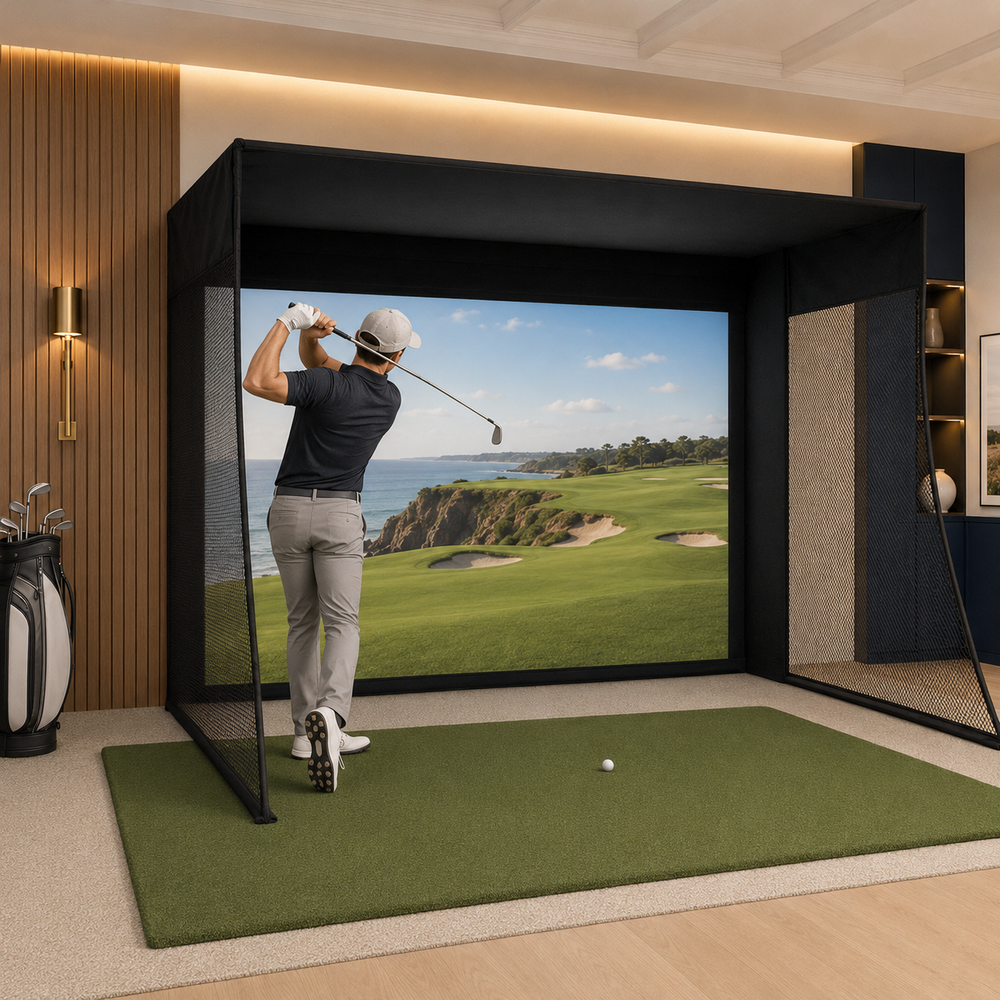 Golfer using a premium indoor golf simulator enclosure and impact screen